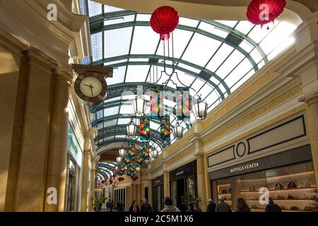 Las Vegas, Nevada, USA - February 20, 2020: Shoppers stroll the promenade past the luxury retail storefronts of the Shops At Bellagio. Stock Photo