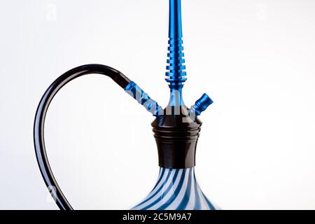 Part of a hookah isolated on a white background. Hookah with black rubber tube and white and blue flask isolated on white background. Stock Photo