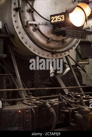 Rusty old valves, gauges and metal parts on an antique steam locomotive ...
