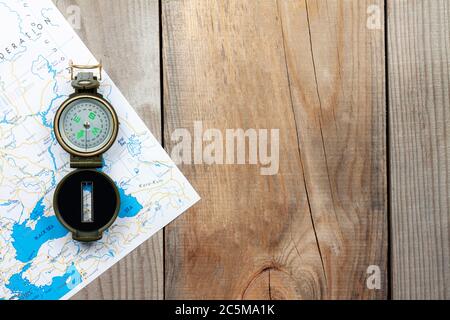Compass and map on a wooden background. Stock Photo