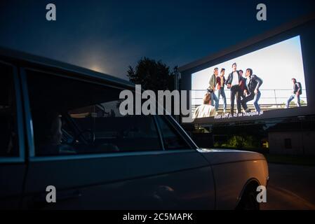 Ptuj, Slovenia. 03rd July, 2020. People in their cars watch a movie 'Grease' with John Travolta and Olivia Newton-John at a temporary drive-in cinema parking lot.Due to the spread of the coronavirus (COVID-19) the City Cinema organised outdoor screening. Credit: SOPA Images Limited/Alamy Live News Stock Photo