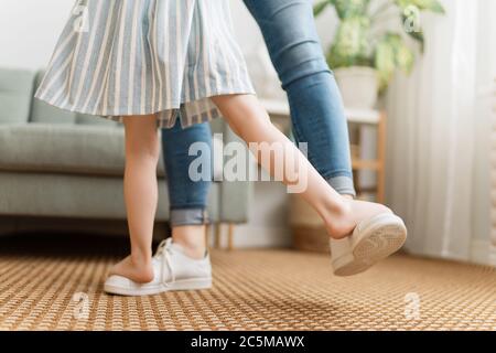 Mom and her daughter child girl are dancing. Family holiday and togetherness. Stock Photo