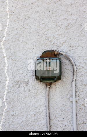 old three phase on worn stone wall Stock Photo