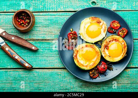 Fried eggs with cherry tomatoes in plate.Fried eggs for healthy breakfast Stock Photo