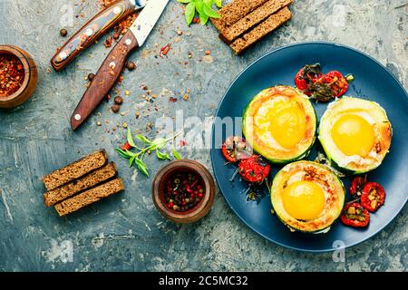 Fried eggs with tomatoes and bread in plate Stock Photo