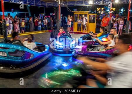 After a day of fasting during Ramadan, Turkish families' enjoy a night time of riding the dodgem cars in the old town of Kaleici in Antalya in Turkey.