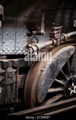 Rusty old valves, gauges and metal parts on an antique steam locomotive ...