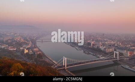 Aerial view to the Elisabeth Bridge and River Danube taken from Gellert Hill on sunrise in fog in Budapest, Hungary. Stock Photo