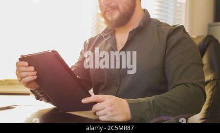 Sunshine portrait of boss using tablet at cabinet. Stock Photo