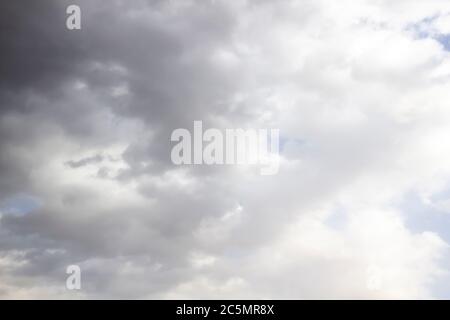 Clouds in the blue sky. A stunning gray sky. The storm is approaching. A beautiful clouds against the blue sky background. Amazing cloud pattern in th Stock Photo
