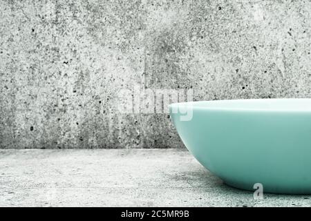 Deep plate on a light background. Glass dishes for the kitchen. close up. Stock Photo