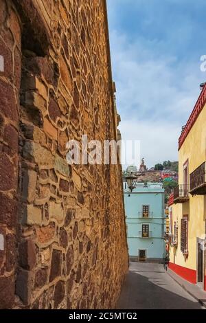 Brick wall at the side of the steps of the University of Guanajuato along Subida de Los Hospitales street Stock Photo
