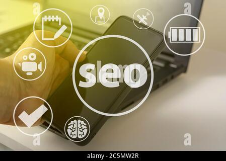 Seo and icons, the concept of development of the system. Information icons on the background of a computer and a person. Stock Photo