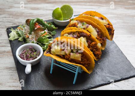 Tacos al pastor, corn tortilla stuffed with meat and spices, typical Mexican food. Stock Photo