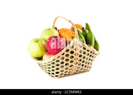 orange, green guava, banana and red apple in bamboo wicker basket on white background fruit health food isolated Stock Photo