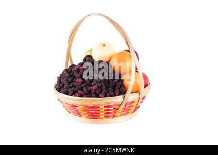 fresh orange, Chinese pear, green apple and mulberry in bamboo wicker basket on white background fruit health food isolated Stock Photo