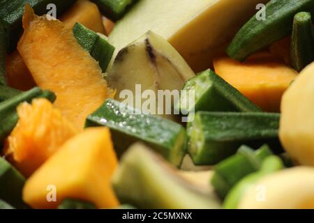 Green chopped ladies finger pieces display with other vegetables together. Stock Photo