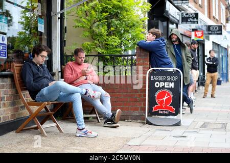 London, UK. 4th July 2020 A barbers shop in Twickenham generates a queue as they open for business after lockdown is eased in England. Credit: Andrew Fosker / Alamy Live News Stock Photo