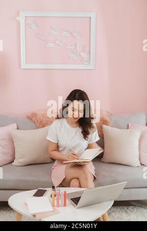 Young asian girl is freelancer with her private business at home office, Working with laptop Stock Photo