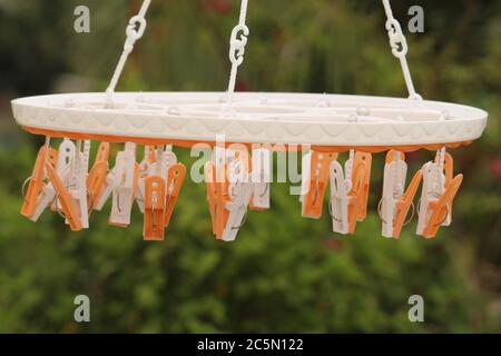 Group of colorful cloth clips used for hanging cloths by it, display with selective focus on daylight. Stock Photo