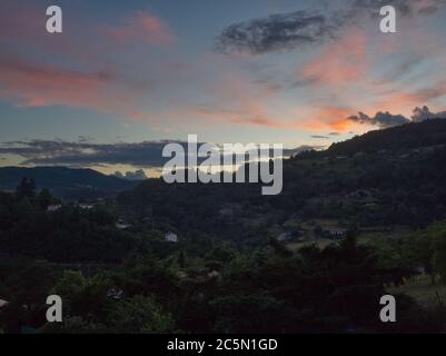 Beautiful colored sky with clouds and mountain crest during the sunset in Ardeche Stock Photo