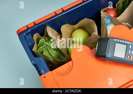 Plastic box with products. Food delivery in platinum boxes. Safe delivery. Storage of fragile goods. Stock Photo