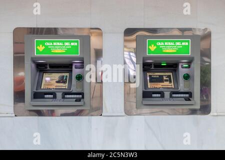 Punta Umbria, Huelva, Spain - June 3, 2020: ATM machines of Caja Rural del Sur bank in the street Calle Ancha in Punta Umbria Stock Photo