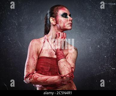 Horror photo of young woman in fake red blood