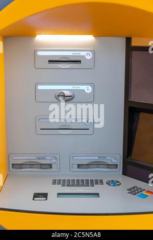 Punta Umbria, Huelva, Spain - June 3, 2020: ATM machines of CaixaBank bank in the street Calle Ancha in Punta Umbria Stock Photo