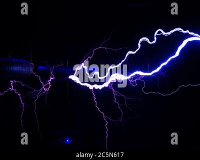 Electric coils emit powerful and bright lightning in the dark Stock Photo