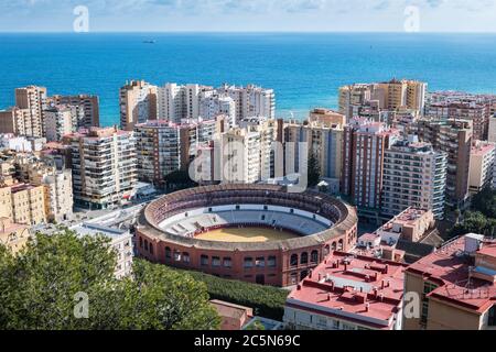 Cityscape of Malaga on a cloudy Winter day, with the bullring to be recognised in the foreground. Stock Photo