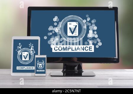 Compliance concept shown on different information technology devices Stock Photo