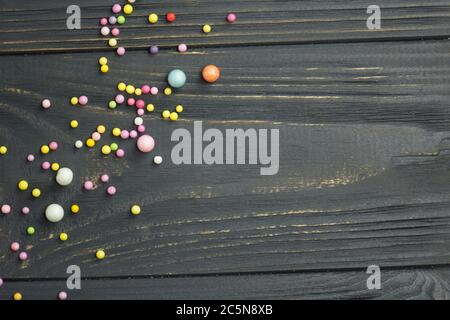 Colorful foam ball texture. Colorful foam ball on a black wooden background Stock Photo