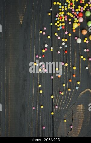 Colorful foam ball texture. Colorful polystyrene foam on a black wooden background Stock Photo