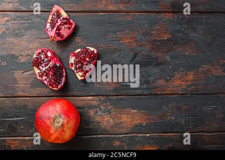 Organic pomegranate over old dark wooden table, top view with space for text. Stock Photo