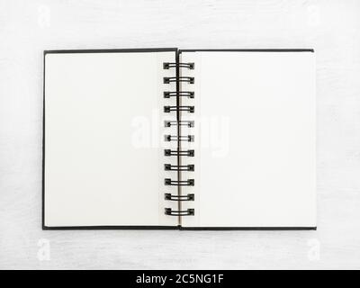Blank notebook lying on a white table Stock Photo