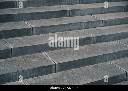 Close up outdoor perspective view of an ancient stone staircase. Pattern of long grey steps. Geometric image with oblique lines. Abstract architectura Stock Photo
