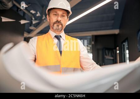 Architect man working with blueprint in the office Stock Photo
