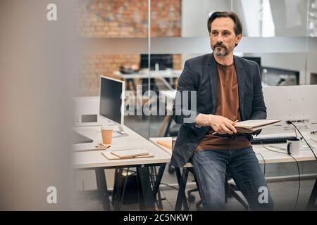 Bearded young businessman working on modern loft office Stock Photo