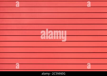 striped iron roller shutters of coral color, metal gate texture. Stock Photo