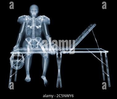 Skeleton of American footballer on sports couch, X-ray. Stock Photo