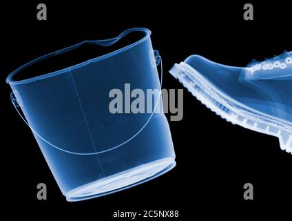 Boot kicking bucket, coloured X-ray. Stock Photo