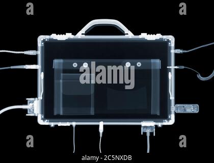 Briefcase with electronic connections, coloured X-ray. Stock Photo