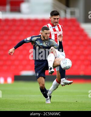 Barnsley's Conor Chaplin (left) and Stoke City's Danny Batth battle for the ball during the Sky Bet Championship match at bet365 Stadium, Stoke. Stock Photo