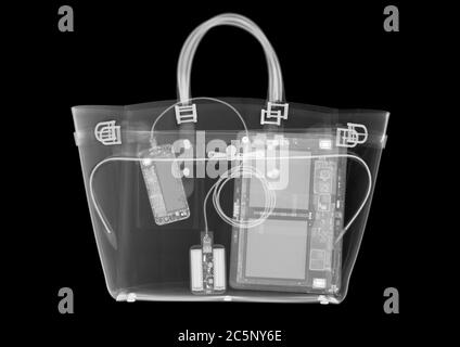 Fashion handbag containing computer devices, X-ray. Stock Photo
