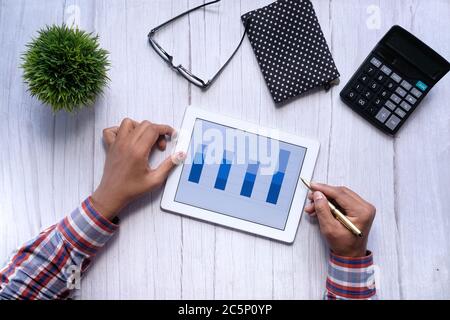 analyzing financial chart on digital tablet at night  Stock Photo