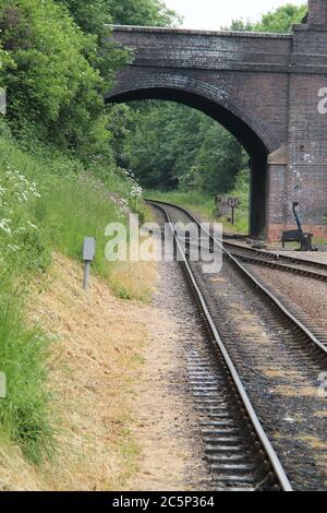 A Brick Bridge Over a Single Track Railway Line. Stock Photo