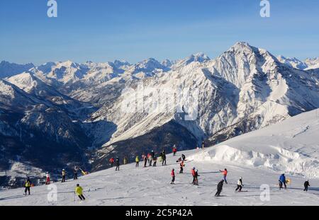 Ski slope in Sauze d'Oulx with many skiers engaged in the Via Lattea ski area Stock Photo