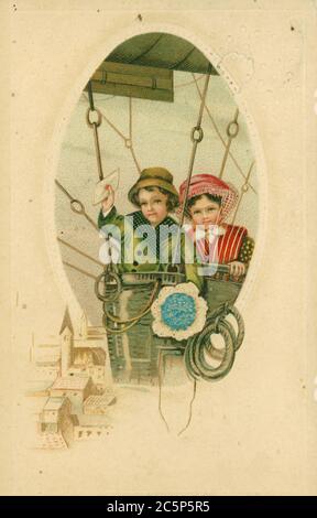 GERMANY - CIRCA 1913: Vintage postcard depicts two children in an air balloon, circa 1913, Germany. A little boy holds an envelope in his raised hand Stock Photo