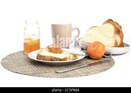 a plate with a slice of egg bread and orange marmalade isolated on white Stock Photo